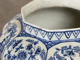 a blue and white vase sitting on a table