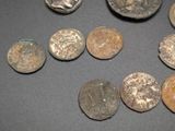 several ancient roman coins are arranged in a circle on a table