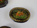 three decorative plates with a painting on them sitting on a table