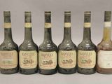 six bouteilles de vin sont alignées sur une table