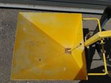 a yellow snow plow sitting on the side of the road