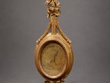 an antique gold clock with ornate decoration on a gray background