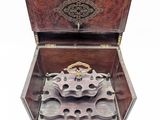 a small wooden box with a clock inside of it