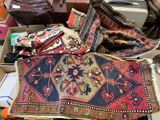 a pile of old rugs and other items on a table