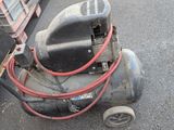 un petit compresseur d'air posé par terre
