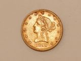 a close up of a gold coin with a woman ' s head on it