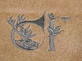 a drawing of a deer and a horn on a brown surface