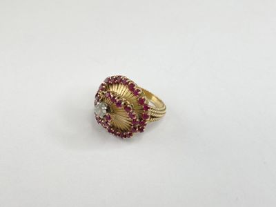 a close up of a gold ring with red and white stones