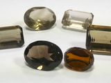a group of five different colored stones sitting on top of a white surface