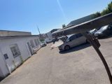 cars parked in a parking lot next to a building and a parking lot with parked cars