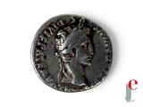 a silver coin with an image of a woman on it