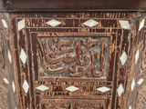 a close up of a wooden table with arabic writing on it