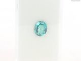 a close up of a blue topaz gems on a white surface
