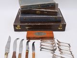 five different types of knives and a book on a table