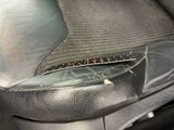 a close up of a car seat with a bug on it ' s arm rest