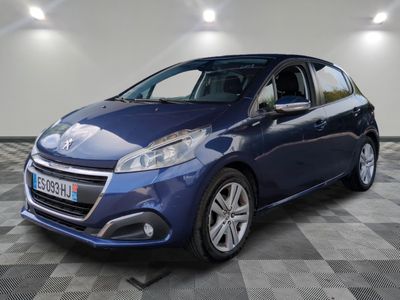 a blue car parked in a garage with a checkered floor