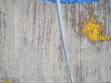 painting of a blue umbrella with yellow flowers on a concrete wall