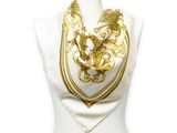 gold and white scarf with a golden dragon on it on a mannequin