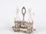 an image of a silver plate with three glass decanters on it