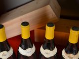 several bottles of wine are lined up on a red table