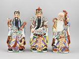 three chinese figurines of a man, woman, and child