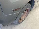 a close up of a car ' s tire with a sticker on it