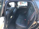 a black car with red trims and a black seat