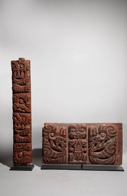 two carved wooden blocks with carvings on them sitting on a table