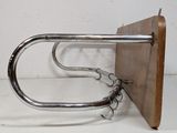 a metal and wood wall mounted rack with hooks on it