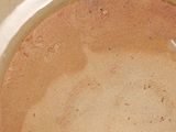 a bowl of soup with a spoon on the side of it