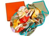 brightly colored silk scarf with orange box on white surface