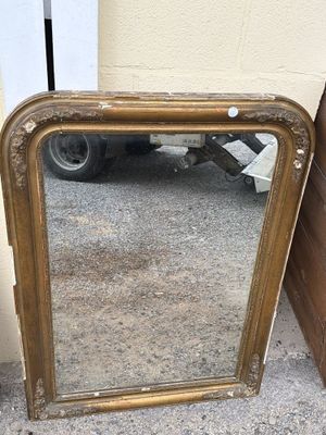 a mirror that is sitting on the ground next to a wall