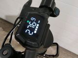 a close up of a bike with a digital display on the handlebars