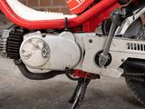 a close up of a red motorcycle parked on the street