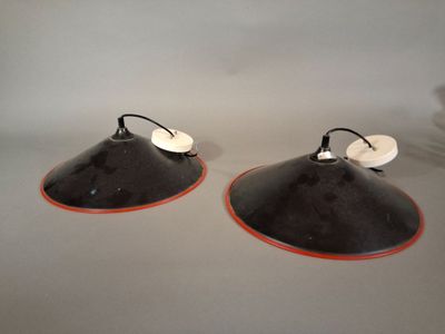 pair of black and white lamps with orange trims on a table