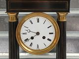 a black and gold clock with roman numerals on it