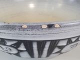 a black and white bowl sitting on a table