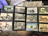 a lot of old photos on a table with a laptop