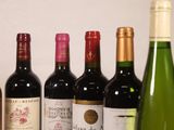 several bottles of wine are lined up on a table