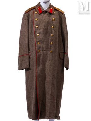 Le manteau est marron et rouge, avec des boutons dorés au niveau du col.