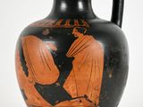 a black and orange vase with a picture of a man on it