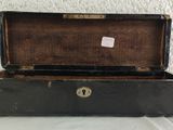 a black suitcase with a key in it on a table