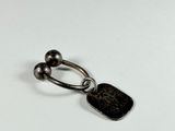 an image of a metal keychain with a coin attached to it