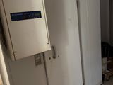 un réfrigérateur dans un coin d'une pièce dont la porte est ouverte