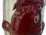 a glass vase with a red fish inside of it