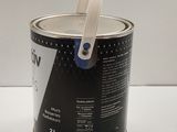 a can of paint on a white table with a blue handle