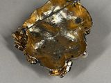 silver and gold plated broochee with a leaf design