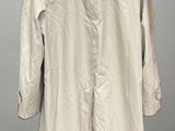 an image of a white coat on a hanger on a wall