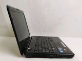 a black laptop computer sitting on a white surface