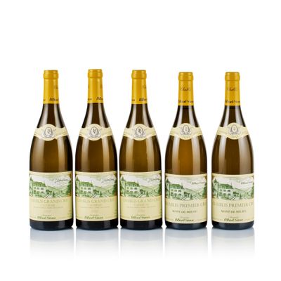 six bottles of wine are lined up on a white surface